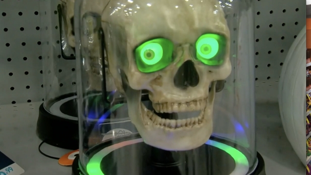 Skull with light-up eyes on a store shelf.