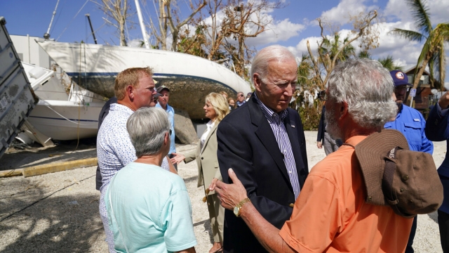 President Joe Biden talks to a person impacted by Hurricane Ian.