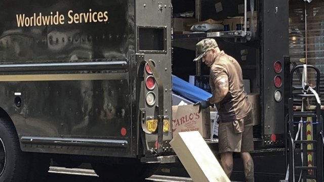 A UPS driver sorts his deliveries.