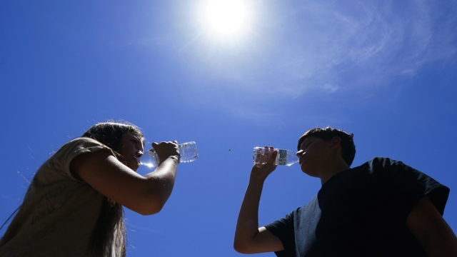 Two people sip water on a hot day