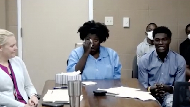 Tiffany Woods is seen wiping her eyes while at a clemency hearing.