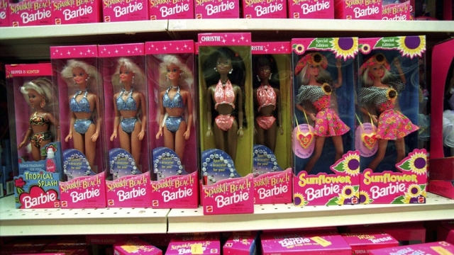 Barbie dolls line the shelves at a toy store in Torrance, Calif.