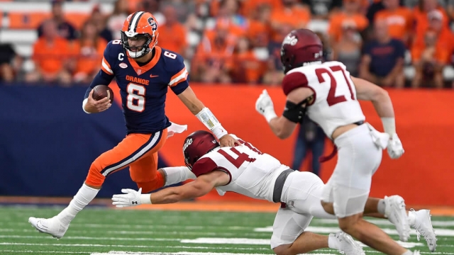 Syracuse quarterback Garrett Shrader avoids tackle by Colgate linebacker Trooper Price during an NCAA college football game.