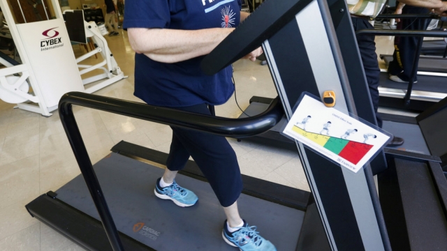 Rita Driscoll works on a treadmill in a supervised exercise therapy program.