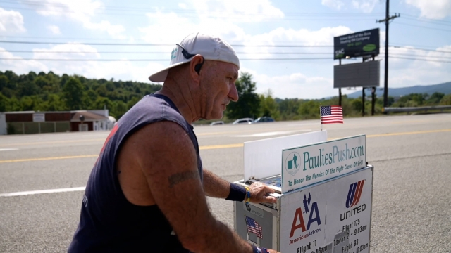 Paul Veneto pushing "Paulie's Push" airline cart in honor of airline workers who died on 9/11.