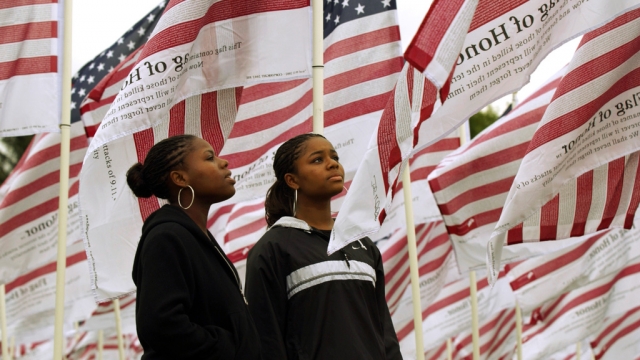 Two sisters read some of the names of 9/11 victims printed on more than 2,600 "Flags of Honor."