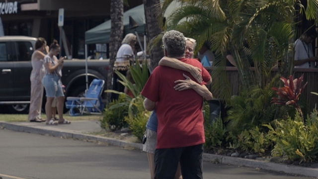 Two Lahaina, Hawaii, residents hug.