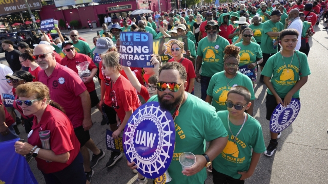 United Auto Workers members walk in a Labor Day parade.