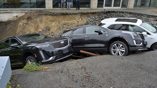 Vehicles washed into a sinkhole after heavy rain in Massachusetts