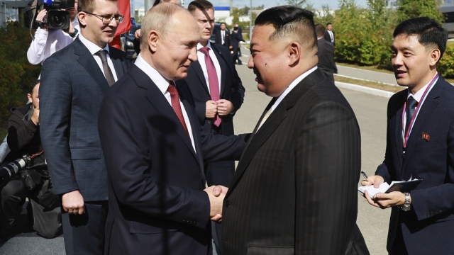Russian President Vladimir Putin and North Korean leader Kim Jong Un shake hands