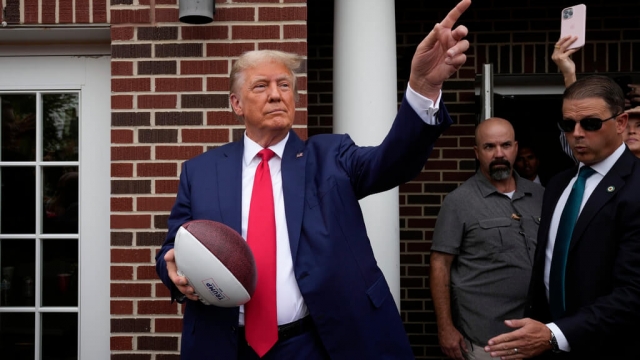 Donald Trump holding a football.
