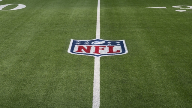 The NFL logo displayed on artificial turf.