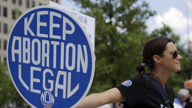An abortion rights demonstrator holds a sign during a rally