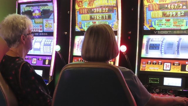 Gamblers play slot machines at a casino