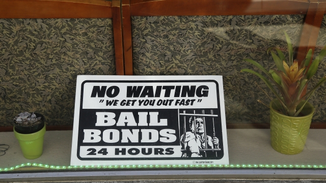 A sign is seen in the window of a bail bonds