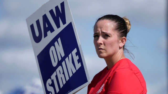 United Auto Workers member Victoria Hall walks the picket line