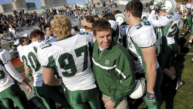 Dartmouth coach Buddy Teevens celebrates with the team after a win
