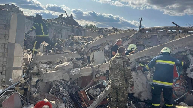 Emergency workers search area where Russian rocket attack killed at least 49 people.