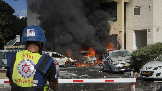 Cars burn after a rocket fired from the Gaza Strip hit a parking lot.