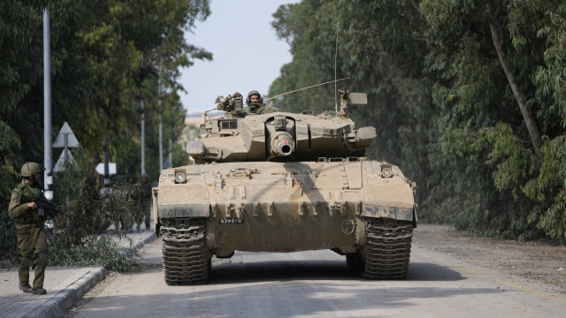 Israeli army tank drives in kibbutz Kfar Azza