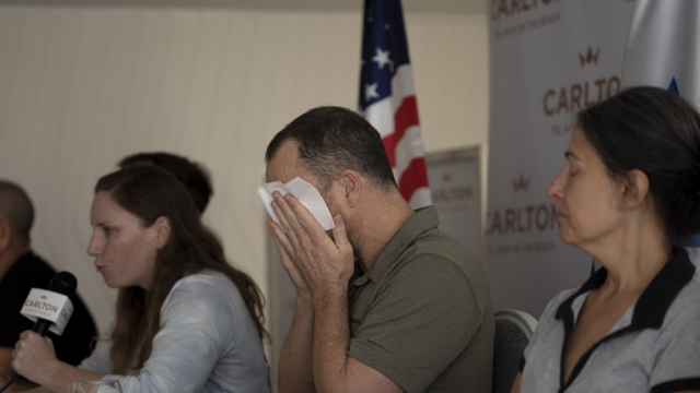 A man whose mother has been missing since a Hamas surprise attack on Israel weeps.