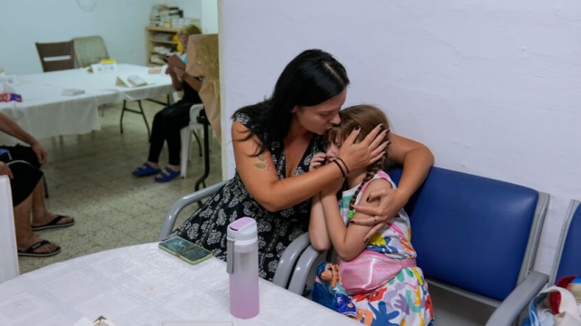 A woman comforts a child in a shelter in Ashkelon, Israel