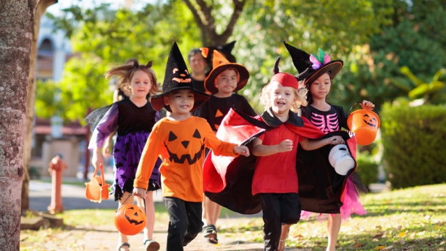 Children with costumes and candy.