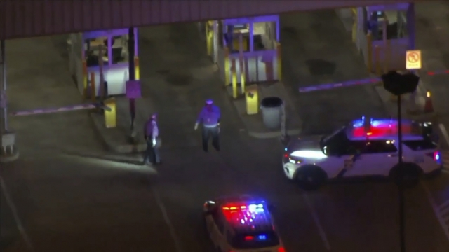 Police cars and officers around a Philadelphia International Airport parking garage.