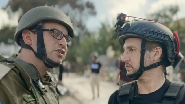 Scripps News National Correspondent Jason Bellini, right, speaks with a member of the Israel Defense Forces.