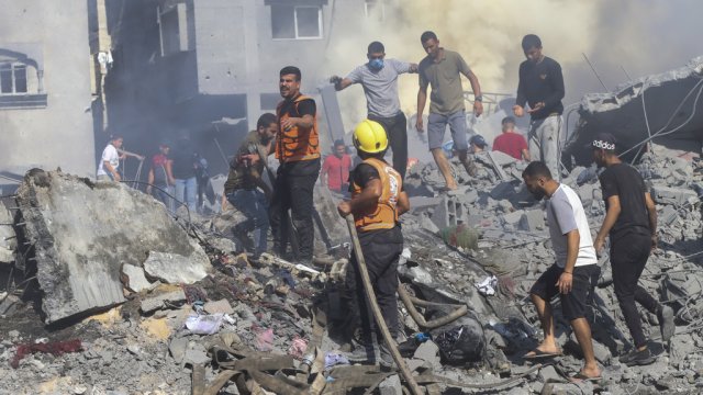 Palestinians search for survivors in the rubble of a family house.