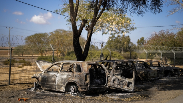 Burned cars next to homes