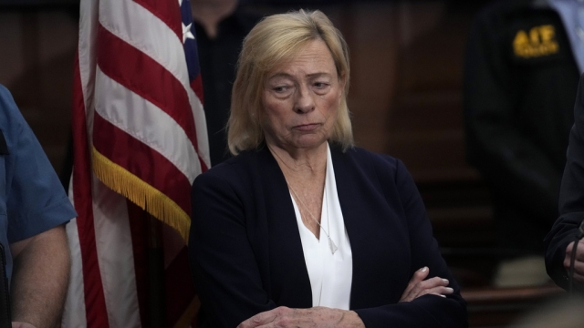 Maine Gov. Janet Mills stands near an American flag.