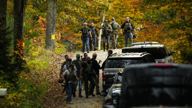 Law enforcement personnel searching in Maine for a mass shooting suspect.