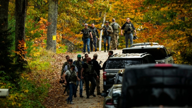 Numerous law enforcement officers are pictured during the search for Robert Card.