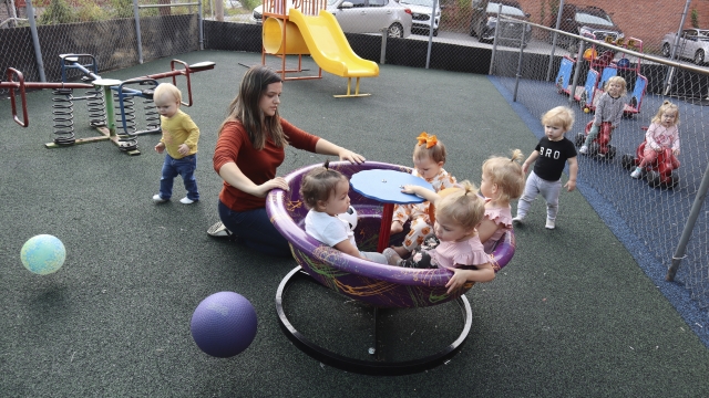 Daycare worker playing with kids