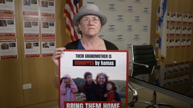 Sandy Feldman holds a poster of her sister held hostage by Hamas.