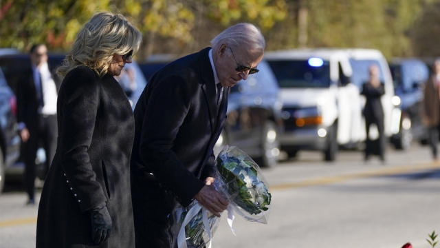 President Joe Biden and first lady Jill Biden lay flowers at one of the sites of last week's mass shootings in Maine.