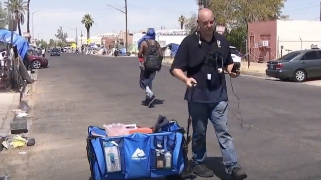 Shane Burdick walks around offering to perform medical services for homeless people in Phoenix