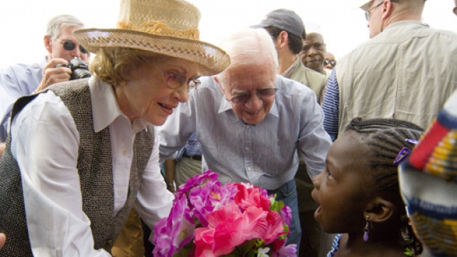 Nigerian girl welcomes former First Lady Rosalynn Carter with flowers February 2007.