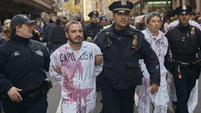 Pro-Palestinian protesters get arrested by the police during the Macy's Thanksgiving Day Parade
