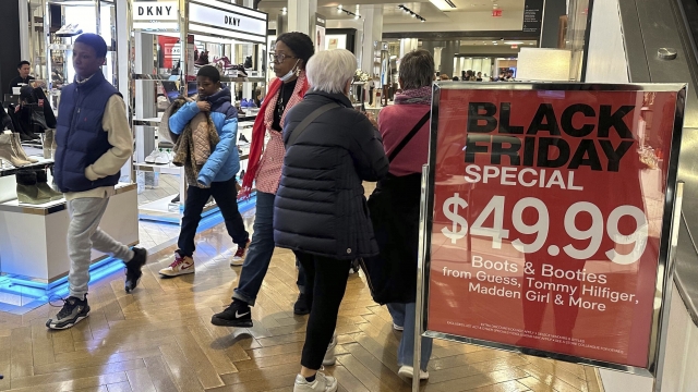 Black Friday shoppers walk through Macy's