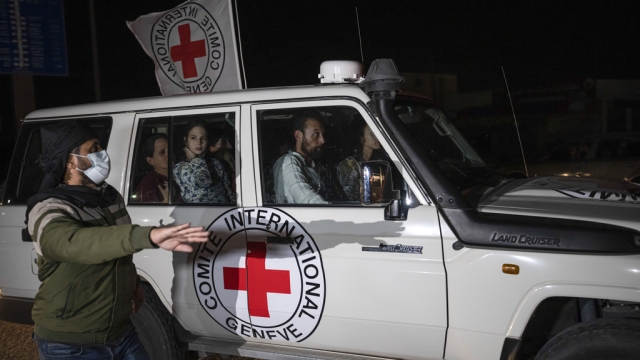 A Red Cross vehicle carrying Israeli hostages drives by at the Gaza Strip crossing into Egypt in Rafah.