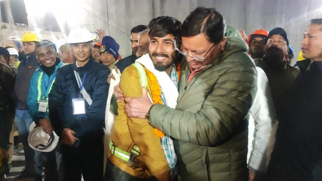 Chief Minister of the state of Uttarakhand, greeting a worker rescued from the site of an under-construction road tunnel.