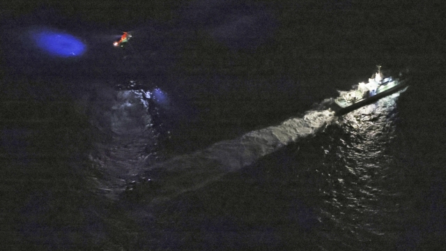 A Japanese coast guard vessel and a helicopter conduct search-and-rescue operation off the coast of Japan