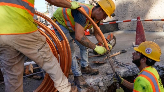 Workmen replace lead water pipes with new copper pipes