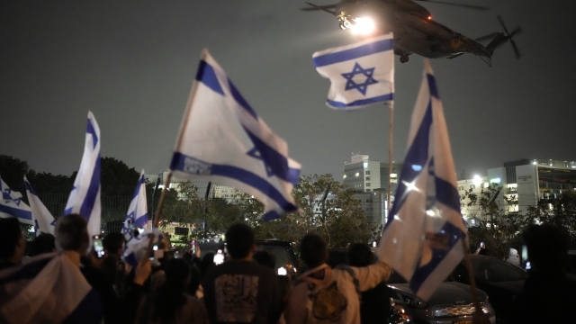 People wave Israeli flags