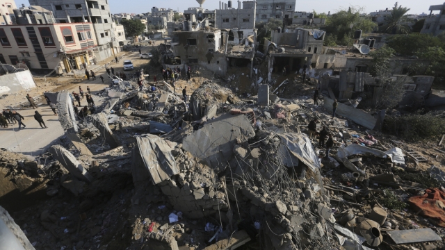 Palestinians look at the destruction by the Israeli bombardment of the Gaza Strip.