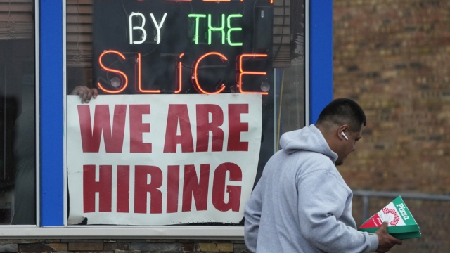 A hiring sign is displayed at a restaurant in Prospect Heights, Ill.