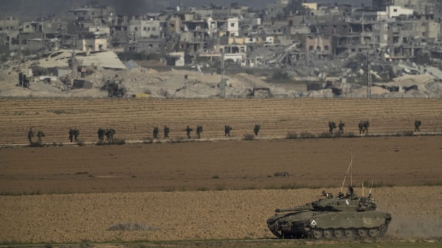 Israeli troops are seen near the Gaza Strip border, in southern Israel on Sunday, Dec. 10, 2023.