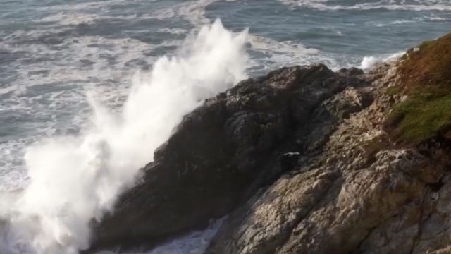 Waves crashing against a cliff